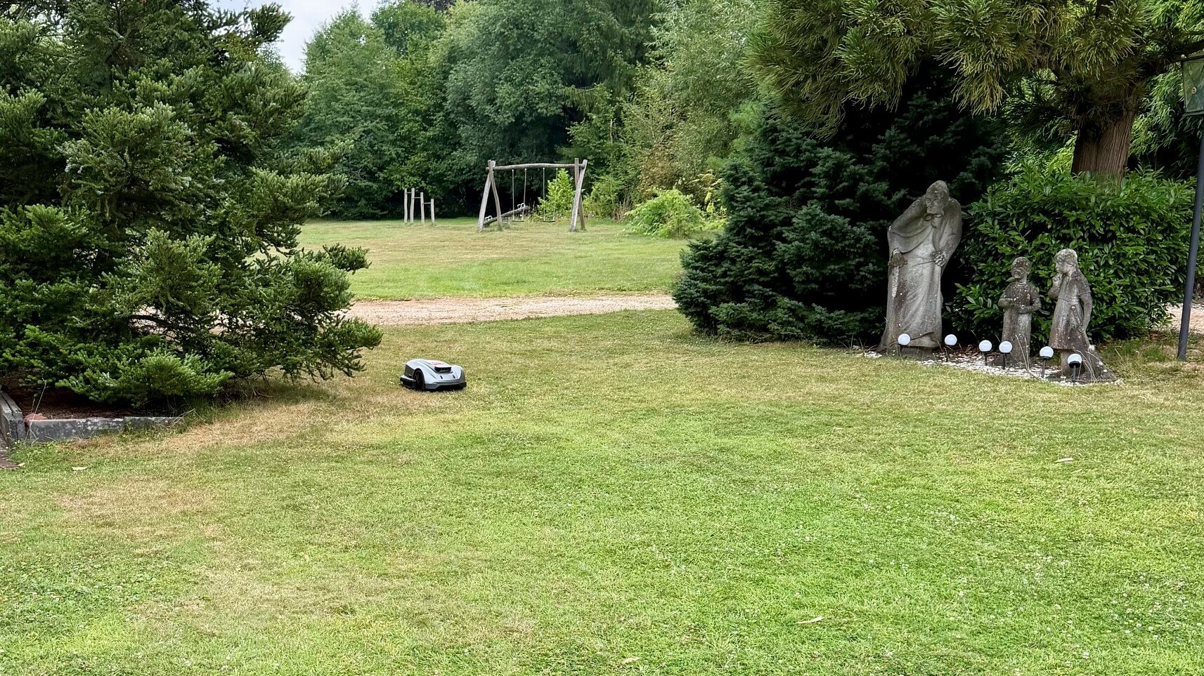 Gretel bei der Arbeit im Park des Waldhotels Mähroboter Gretel bei der Arbeit auf der Wiese vor dem Hänsel-und-Gretel-Haus